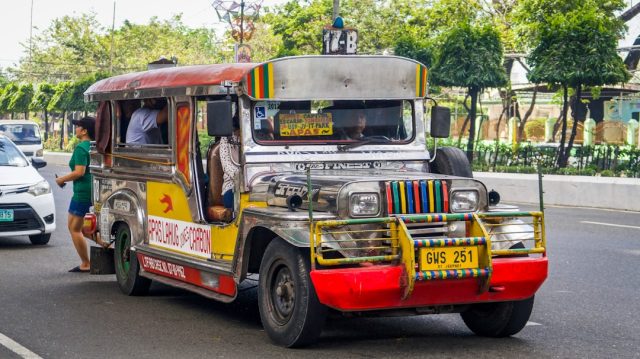 Jeepney Crash in Oriental Mindoro Highlights Systemic Safety Issues A colorful jeepney with chrome details and hand-painted scenes on a rural road in Oriental Mindoro, Philippines.